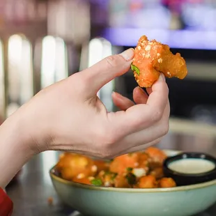 a person holding a piece of food