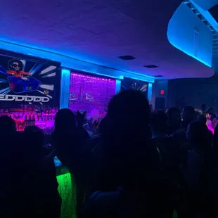 a crowd of people in a dimly lit room