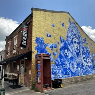 a blue and white mural on the side of a building