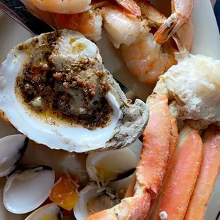 Melange of items: chargrilled oysters, crab legs, peel and eat shrimp, little neck clams