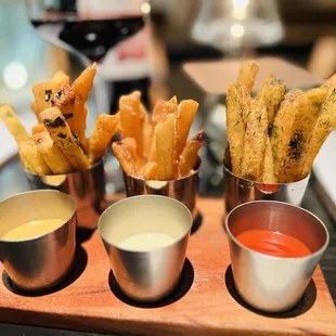 left to right: furikake fries with sesame mayo, parmesan fries with truffle cream, and house fries with yuzu ketchup