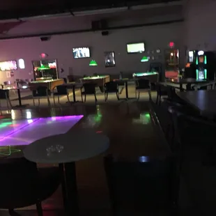 tables and chairs in a dimly lit room
