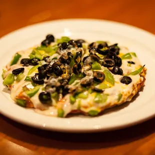 a pizza with black olives