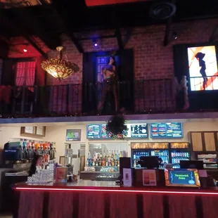a bar with a statue of a woman