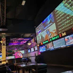 a bar with a lot of tv screens