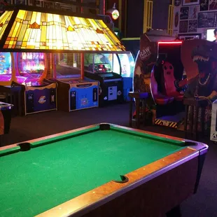 a pool table and arcade machines