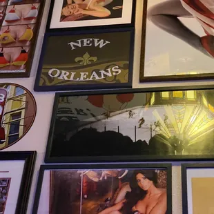 a wall of framed photos of women