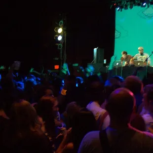 a crowd of people watching a man on stage