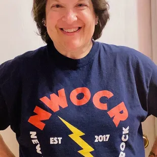 a woman wearing a t - shirt that says swocr