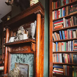 a fireplace and bookshelf