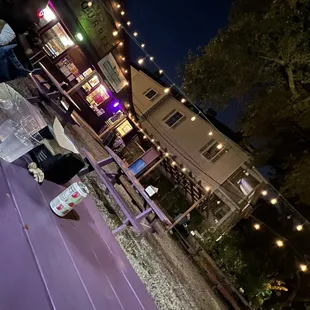 a purple bench with a bottle of beer on it