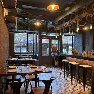 the interior of a restaurant with tables and chairs