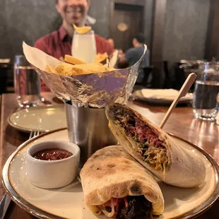 a man sitting at a table with a plate of food