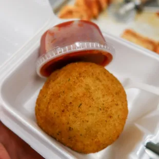 a sandwich and ketchup in a styrofoam container