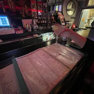 a bartender pouring a drink