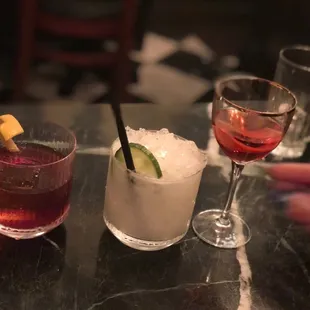 three cocktails on a table