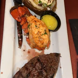 Steak and lobster tail with baked potato
