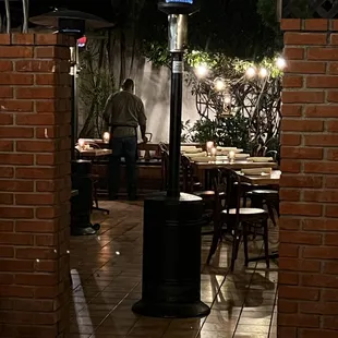 a patio with tables and umbrellas