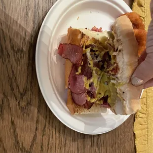 Inside of the sandwich-- made right with Swiss, mustard and pickles.