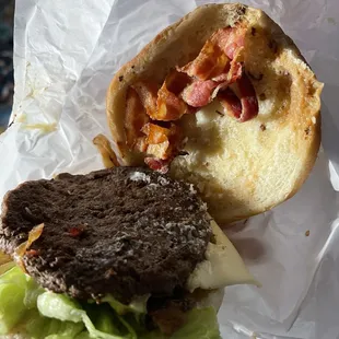 Pathetic excuse for a mushroom burger with only one piece of bacon on half of the burger.