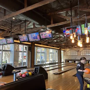 a bowling alley with people playing bowling