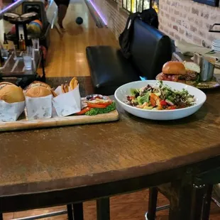 a bowl of food on a table in a bowling alley