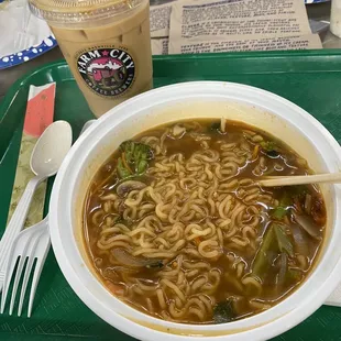 a bowl of ramen and a drink on a tray