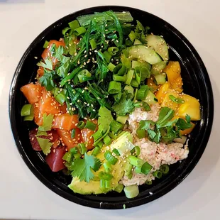 a black bowl with a variety of vegetables