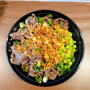 a bowl of food with meat and vegetables