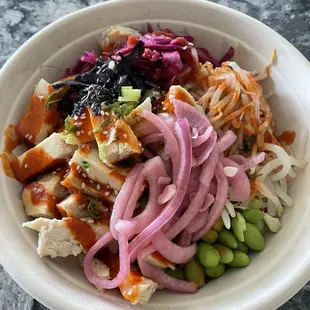 Chicken bowl with spicy bibimbap, pickled onions, edamame, cabbage, seaweed, green onion, &amp; bean sprouts