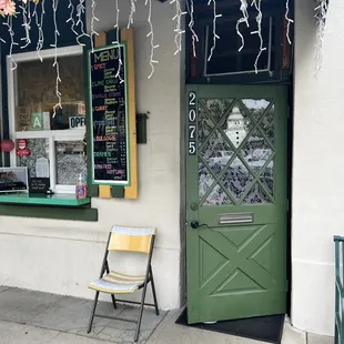 a green door and a yellow chair