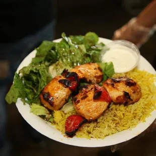 a person holding a plate of food