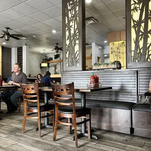 people sitting at tables in a restaurant