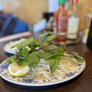 a plate of noodles and a lemon