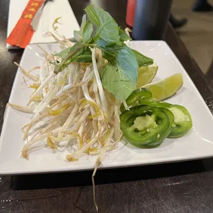 a plate of sprouts and lime