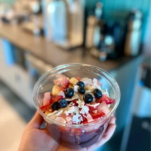 a person holding a bowl of food