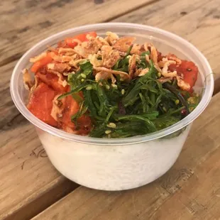 a bowl of food on a wooden table