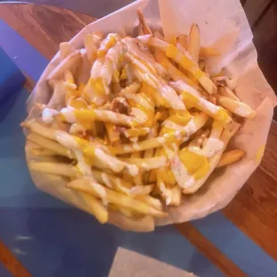Loaded fries - cheese bacon with a drizzle of ranch is the description.