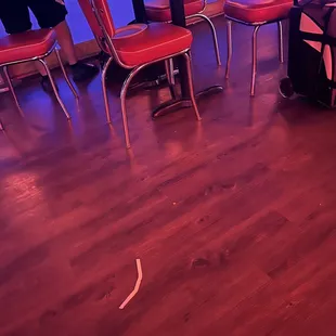 Dirty plate from previous people on the seat and trash on the floor.