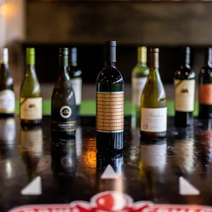 a row of wine bottles on a table