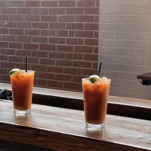 two glasses of bloody drink on a table
