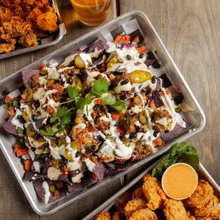 two trays of food and a glass of beer