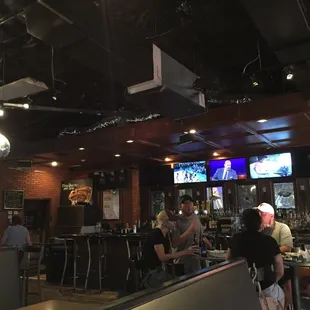people sitting at tables in a sports bar