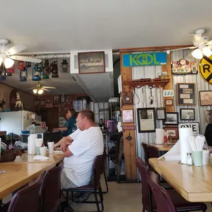 people sitting at tables in a restaurant