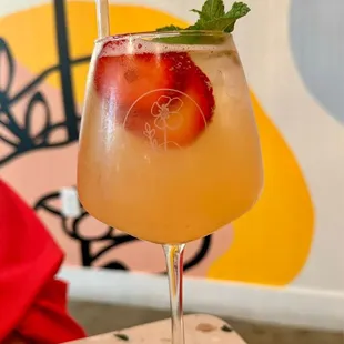 Caroline's hat (gin Prosecco Rose, lemon juice, strawberry syrup, mint, topo chico.