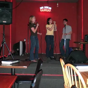 a group of people singing on stage