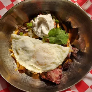 Southwestern Skillet with crisp potatoes, Pico de Gallo, cheese, eggs, sourcream and steak tips.