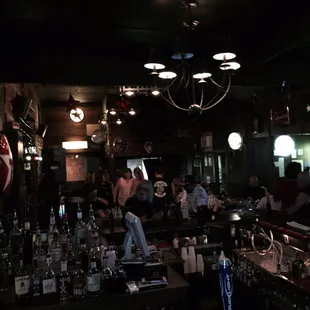 people sitting at a bar watching television