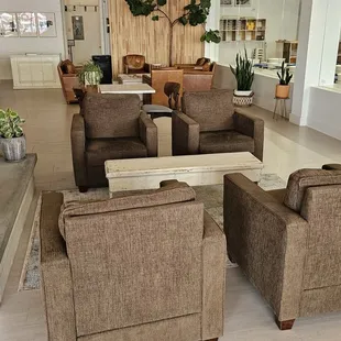 a living room with couches and chairs