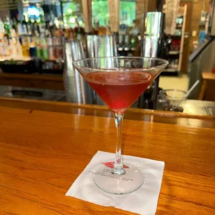 a glass of wine on a bar